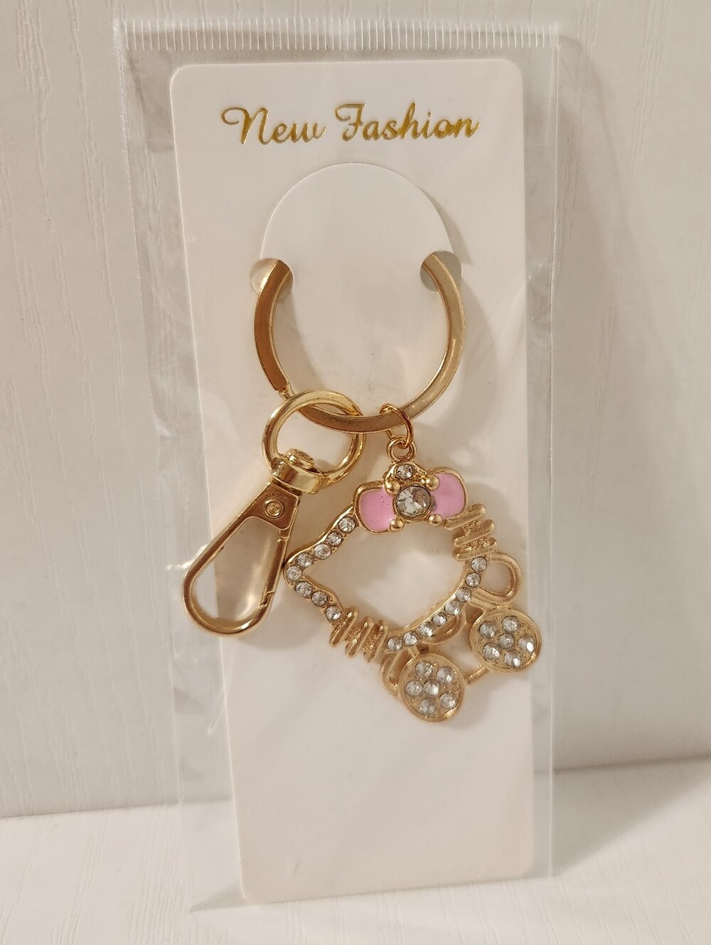 Gold-Tone Hello Kitty Keychain with Pink Enamel And Rhinestone Accents
